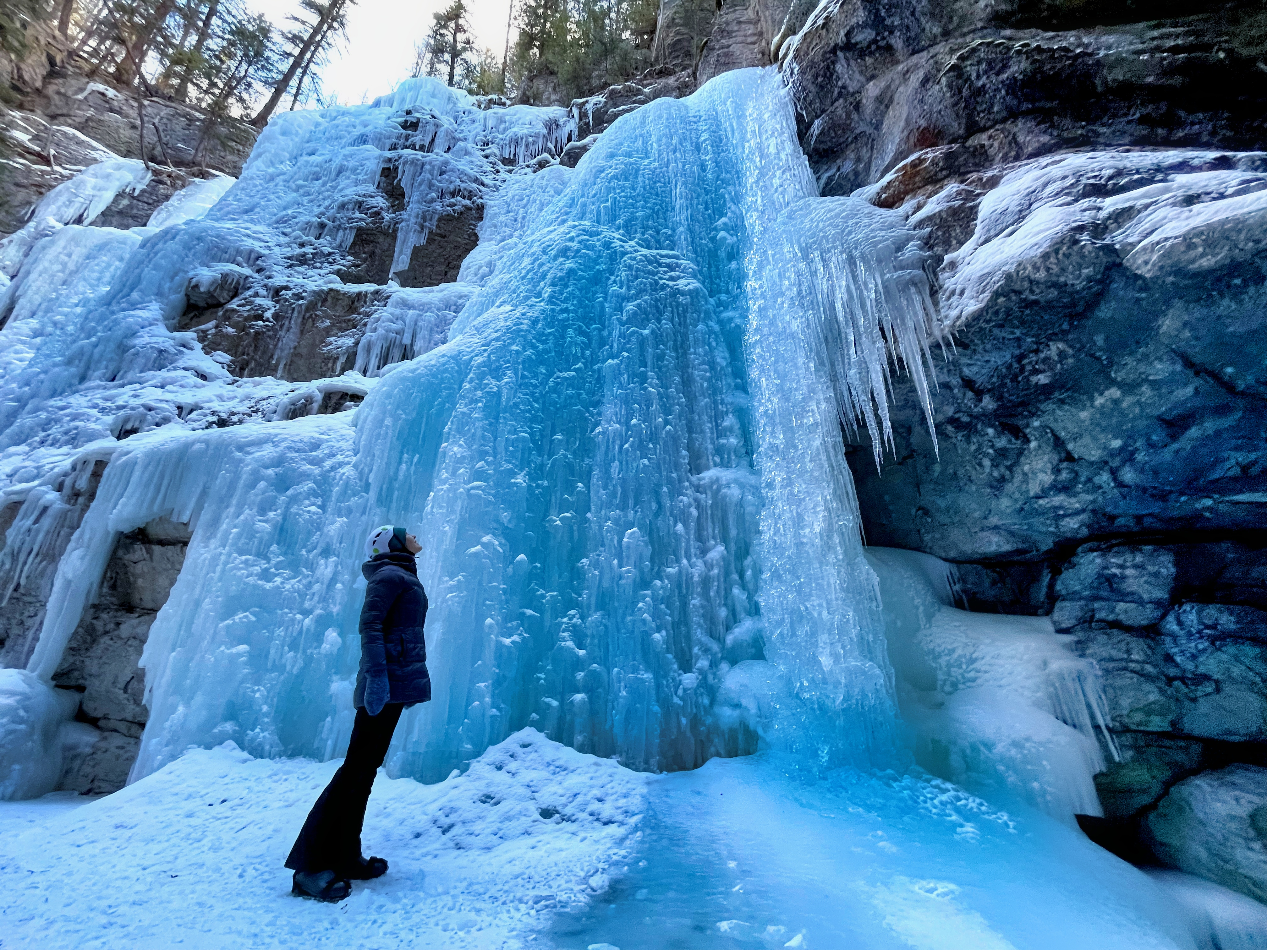 Standing by a frozen waterfall